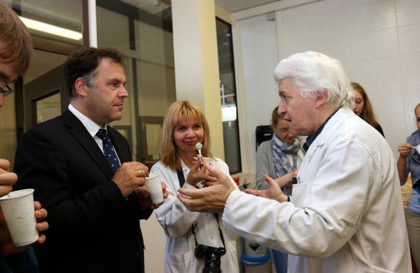Kultusminister Stephan Dorgerloh, Prof. Carola Griehl und Hochschulmitarbeiter Wolfgang Faber (v.l.) testen im Labor ein Softeis mit Algen.