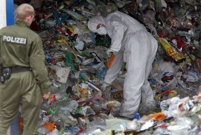 Polizisten mit Schutzanzügen durchsuchen am 22.04.08 in Wiesa bei Annaberg-Buchholz (Erzgebirge) auf dem Gelände einer Recyclingfirma, in der eine Babyleiche gefunden wurde, den Müll. (FOTO: DDP)