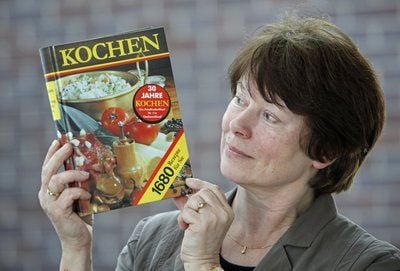 Christa Winkelmann, Geschäftsführerin des Buchverlag für die Frau, hält das Buch «Kochen» in Leipzig in den Händen. Der Klassiker ist mittlerweile mehr als eine Million mal verkauft worden. Es ist somit eines der wenigen Bücher, welches trotz den Wende- und Nachwendewirren kontinuierlich verlegt wird. Was auf den Tisch kam, hatte in der DDR der Verlag für die Frau in der Hand. (FOTO: DPA)