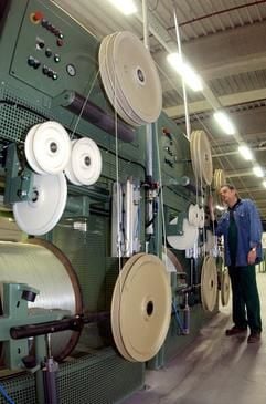 Ein Mitarbeiter überprüft am Freitag (29.11.2002) in der Polystal Composites GmbH Haldensleben (Ohre-Kreis) die Produktion von Hochleistungsverbundstoffen. Das Unternehmen hat am Freitag ein neues Werk offiziell inBetrieb genommen. In die neue Produktionsstätte hat das seit 1995 in Haldensleben ansässige Unternehmen eigenen Angaben zufolge über drei Millionen Euro investiert. Die 45 Beschäftigten stellen Verbundwerkstoffe her, die unter anderem bei der Fertigung von Glasfaserkabeln benötigt werden. Zu den Kunden in mehr als 25 Ländern in Europa, Amerika und Asien gehören namhafte Firmen wie Alcatel, Corning Cable Systems und Pirelli. (Foto: dpa)