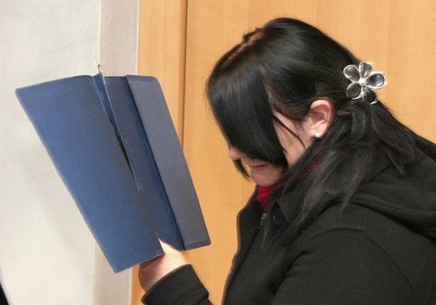 Die Angeklagte Melissa I. versteckt im Landgericht Magdeburg ihr Gesicht hinter einem Hefter. (FOTO: DPA)