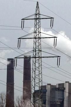 Ein Strommast vor einem Kraftwerk. (Foto: dpa)