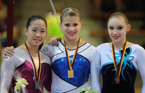 Die Turnerinnen Kim Bui (l-r), Elisabeth Seitz und Nadine Jarosch während der Siegerehrung des Mehrkampf-Wettbewerbs bei den Deutschen Meisterschaften im Turnen in der EWS-Arena in Göppingen. (FOTO: DPA)