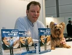 Auch das war Buchmesse: «Daisy», das Schoßhündchen des ermordeten Modezaren Rudolph Moshammer, sitzt am Sonntag (19. März) während einer Signierstunde neben dem Buch «Mosi, Daisy und ich». (Foto: dpa)