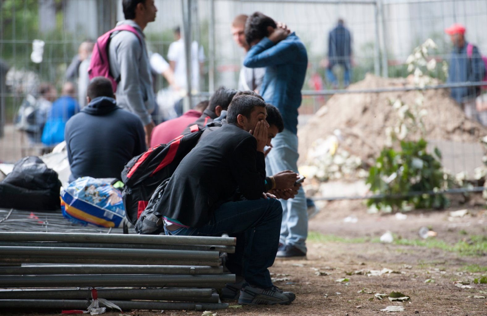 Flüchtlinge sitzen in Berlin auf dem Gelände des Landesamtes für Gesundheit und Soziales.