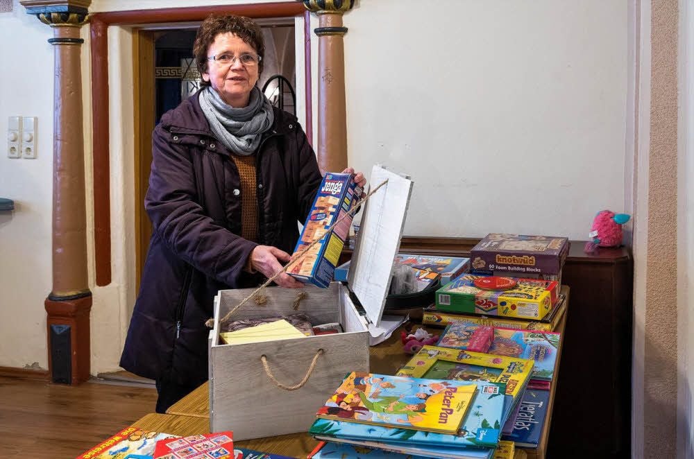 Jugendclub-Leiterin Gundula Winzer packt im Ratskeller die gespendeten Spiele und Bücher aus.