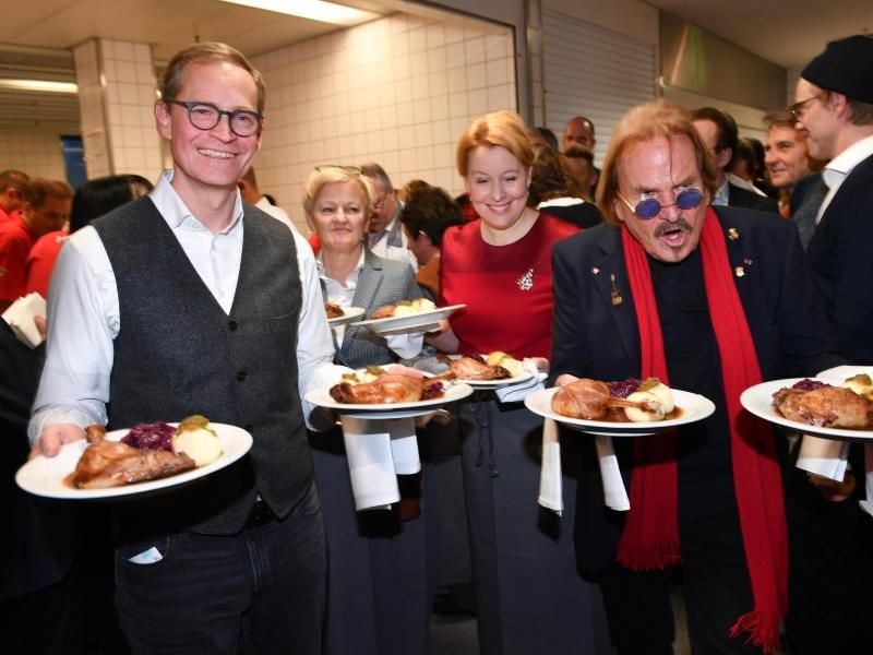Michael Müller (l-r), Renate Künast, Franziska Giffey und Frank Zander servieren im Hotel Estrel Gänsebraten für die Gäste. Foto: Jens Kalaene