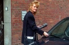 Eine Politesse steckt ein «Knöllchen» an ein falsch geparktes Auto. (Foto: dpa)