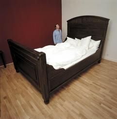 Ein Mann im Pyjama steht vor einem überdimensionalen Bett im Künstlerheim Luise in Berlin (Foto undatiert). Das Konzept, ein Hotel mit Kunst zu gestalten, hat sich inzwischen durchgesetzt. Im Hotel Künstlerheim Luise haben die Künstler besonders viel Einfluss: Jeder gestaltet ein Zimmer in völliger Eigenregie und erhält fuenf Prozent des Raum-Erlöses. "Einzige Bedingung ist eine gastliche Atmosphäre", sagt der Galerist Christian Bree. (Foto: ddp)