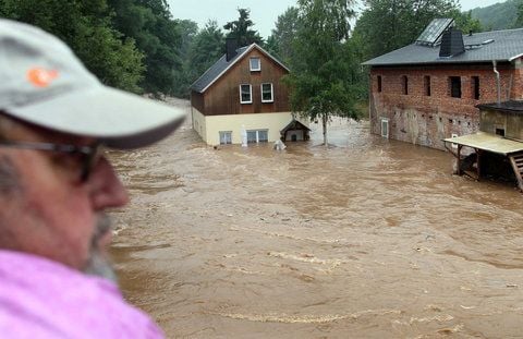 Ein Mann blickt in Chemnitz auf Häuser, die vom Hochwasser des Flusses Chemnitz vollständig umspült werden. (FOTO: DDP)