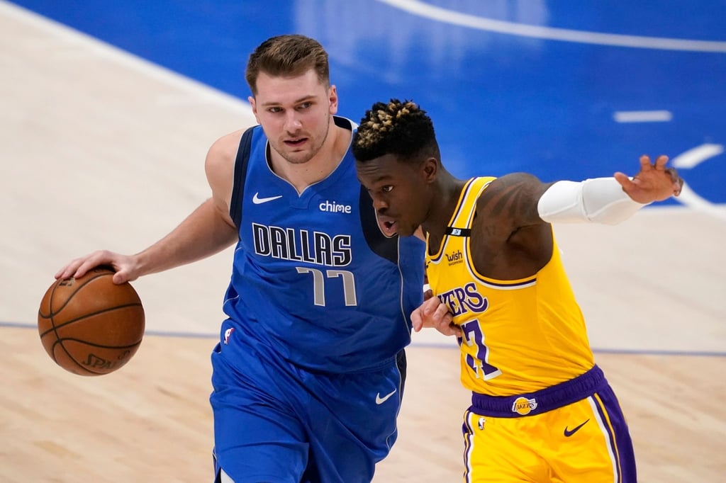 Dennis Schröder (r) von den Los Angeles versucht Mavericks-Star Luka Doncic vom Ball zu trennen.
