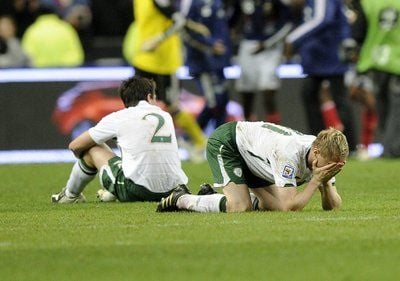 Die Iren Sean Saint Ledger (l.) und Damien Duff (r.) sitzen verzweifelt am Boden, weil sie die WM-Qualifikation gegen Frankreich verpasst haben. (FOTO: DPA)