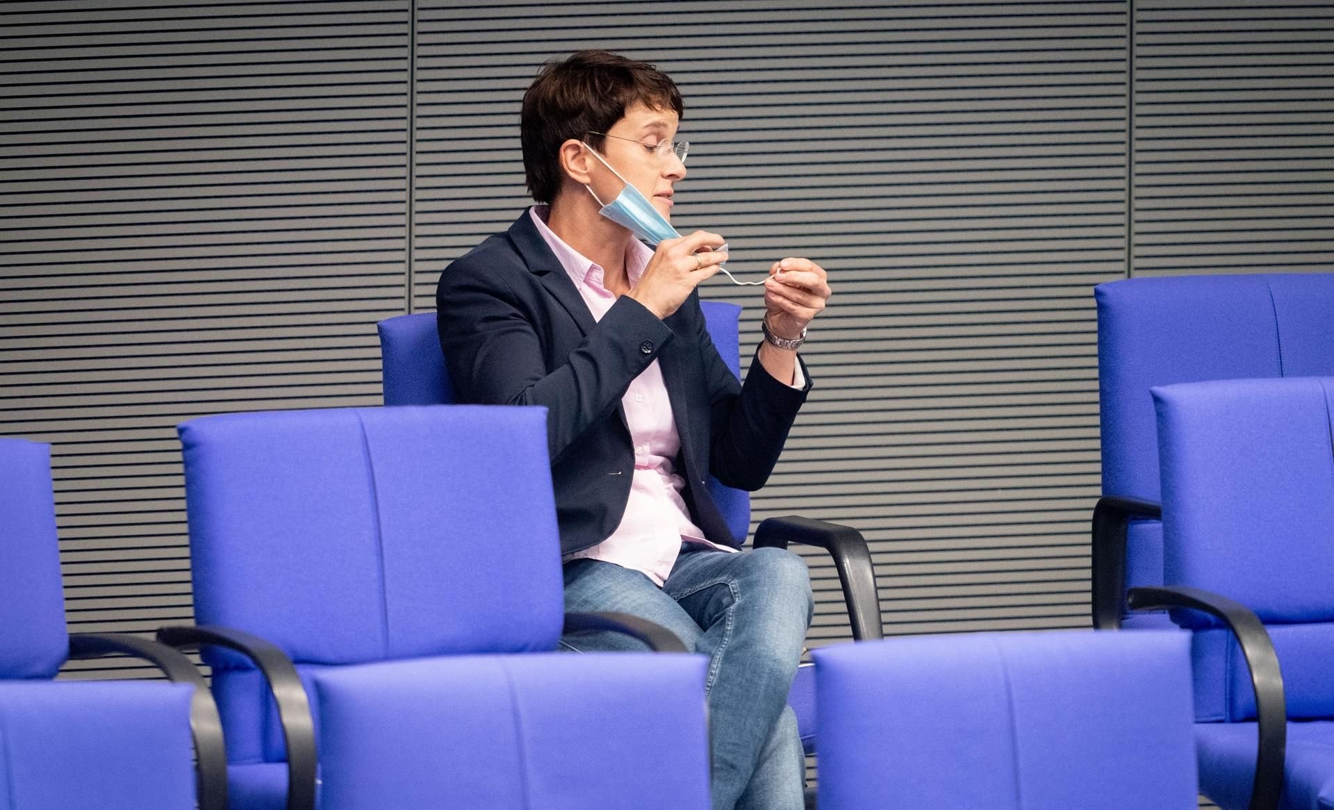 Frauke Petry, parteilos, schaut ihre Mund-Nasenbedeckung während der Sitzung des Bundestags an.