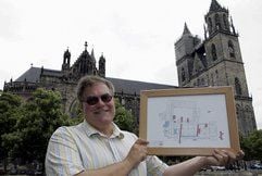 Archäologe Rainer Kuhn hält vor dem Dom in Magdeburg einen archäologischen Lageplan des Domes. Ab Oktober werden die im Sommer unterbrochenen archäologischen Grabungen im Magdeburger Dom fortgesetzt. (Foto: ddp)