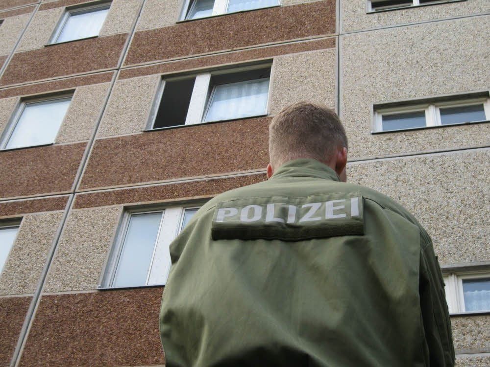 Ein Polizist steht vor der Wohnung der Frau im Stadtteil Othal. Die Räume wurden gestern stundenlang von Beamten der Kriminaltechnik durchsucht.