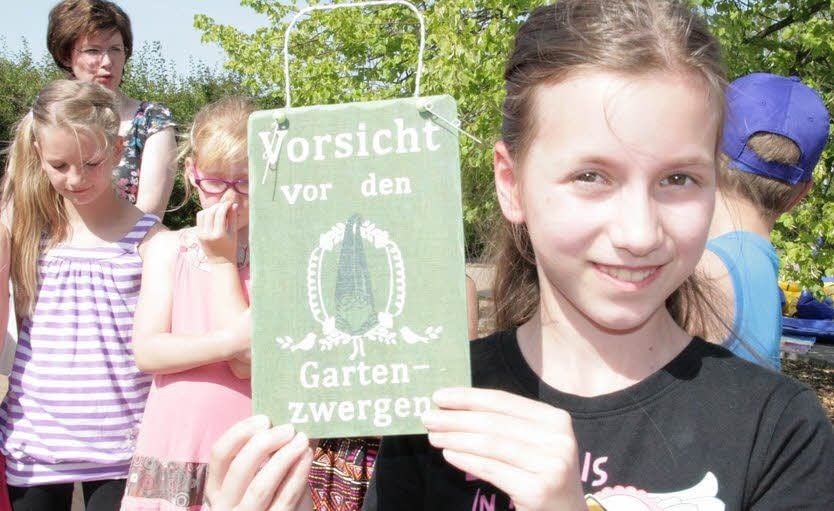 Kira Scherr arbeitet gern im Schul- und Wettergarten. „Da wohnen auch Zipfelmützen“, lässt sie wissen und stellt augenzwinkernd ein Hinweisschild auf.