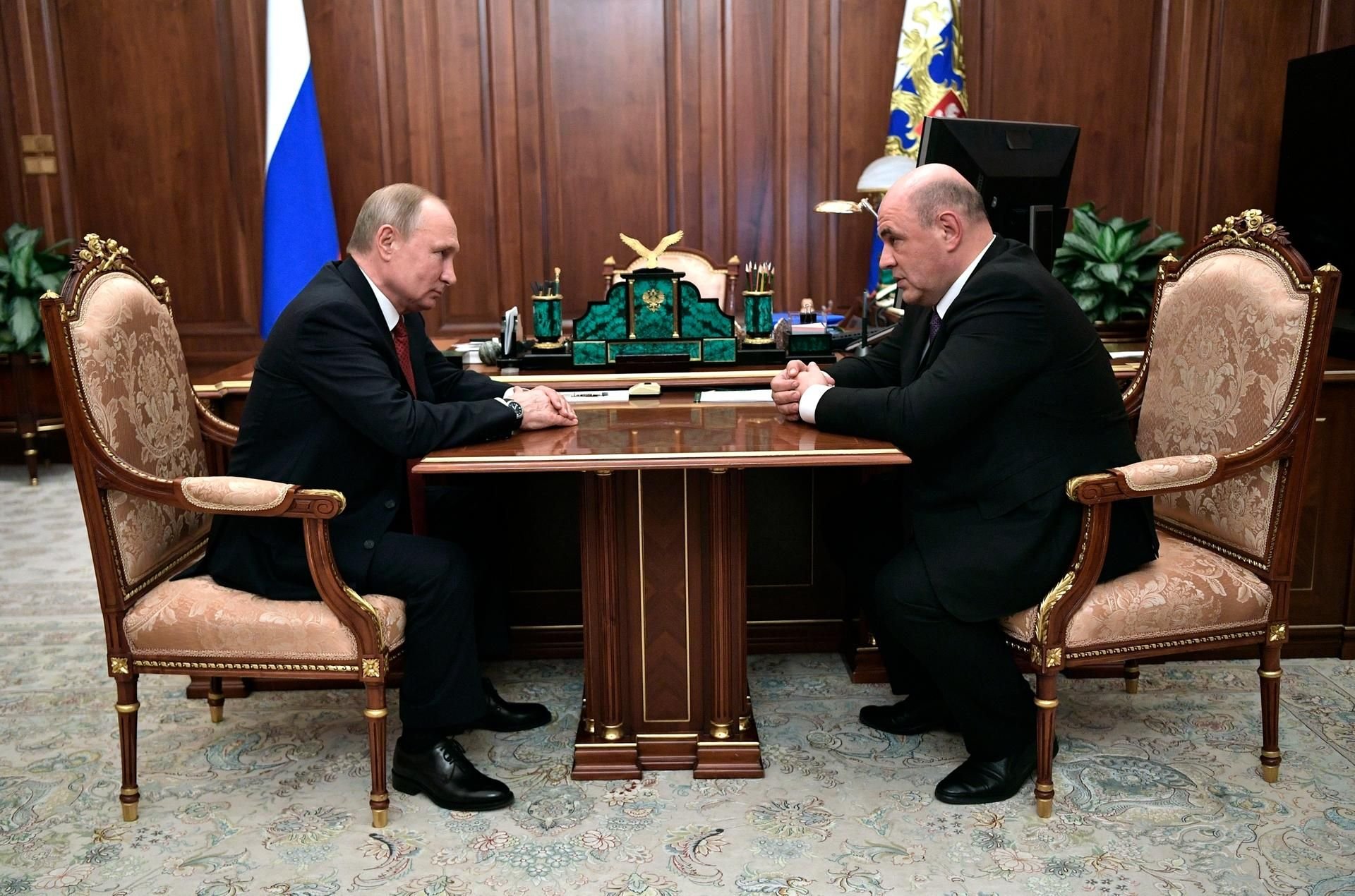 Wladimir Putin, (l) Präsident von Russland, spricht mit Michail Mischustin, Leiter der russischen Steuerbehörde während ihres Treffens im Kreml.