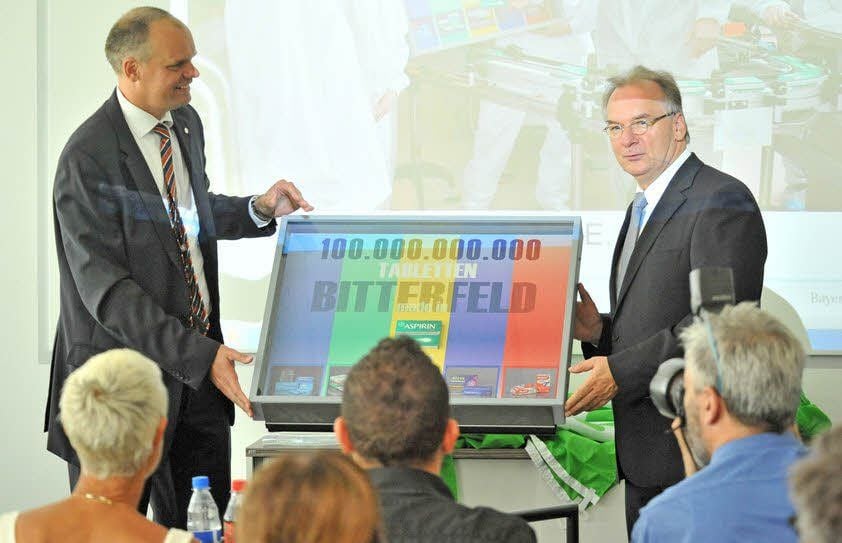 Die 100-milliardste Tablette aus Bitterfeld überreicht Geschäftsführer Christian Schleicher Ministerpräsidnet Reiner Haseloff (r).