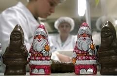 Zwei Mitarbeiterinnen der Wergona Schokoladenfabrik in Wernigerode verpacken am Dienstag (28.10.03) an einer Produktionslinie fuer Schokoladenweihnachtsmaenner. (Foto: dpa)