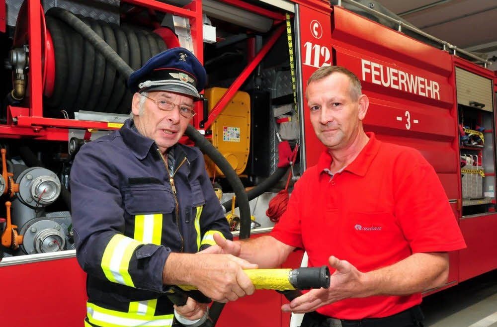 Wehrleiter Erhard Hödel (links) und Hans-Ulrich Schlegel, Chef des Feuerwehrvereins, stehen vor einem Großtanklöschfahrzeug, das dem Verein gehört und auch für die Stadt Weißenfels zum Einsatz kommt.