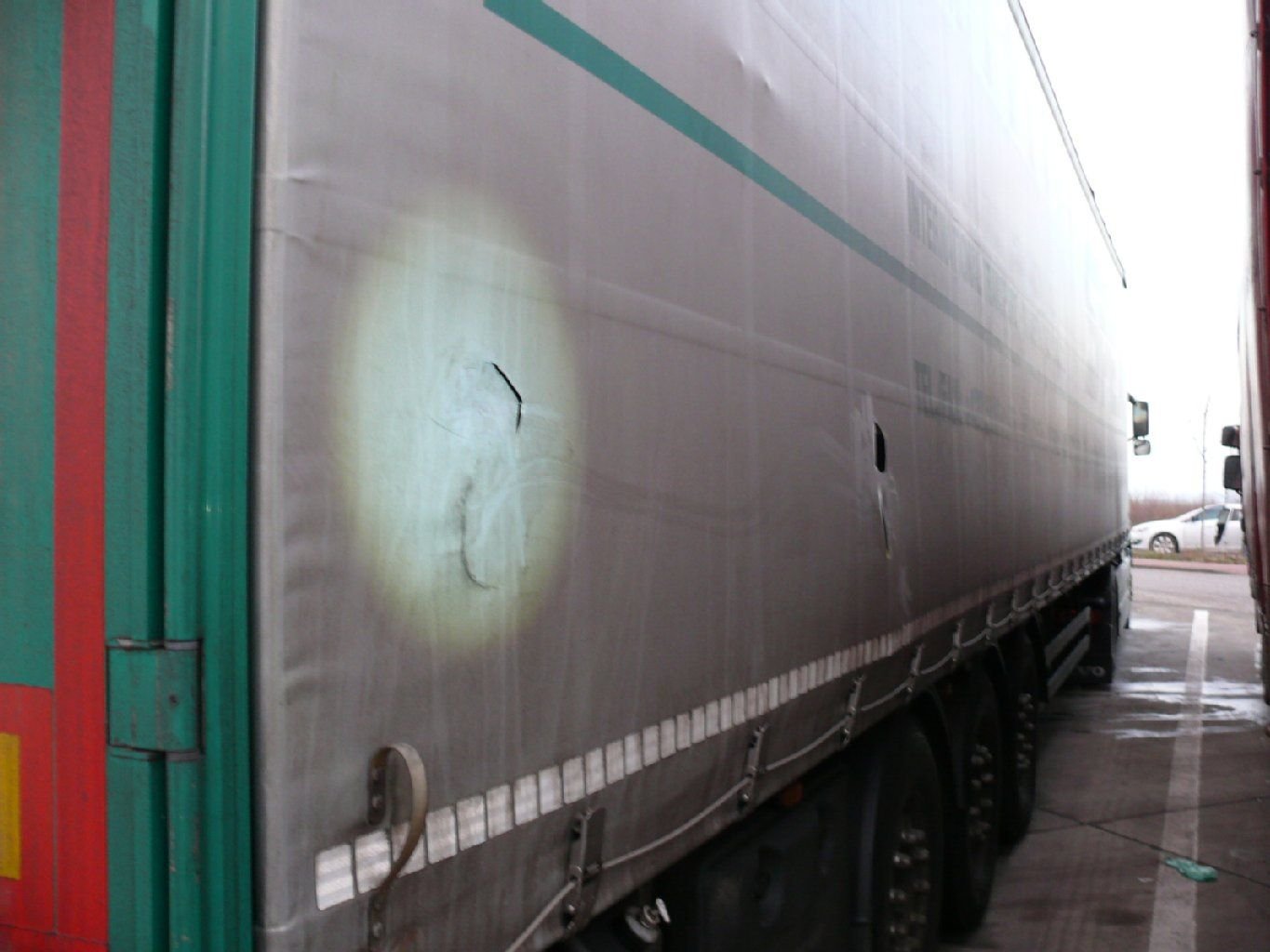 Ein Lastwagen mit aufgeschlitzter Plane.