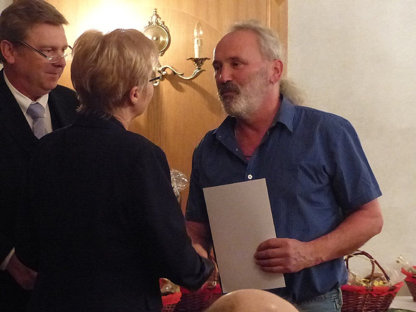 Hans-Ulrich Wolff (rechts) erhält die Glückwünsche von Petra Döring und Veit Wolpert.