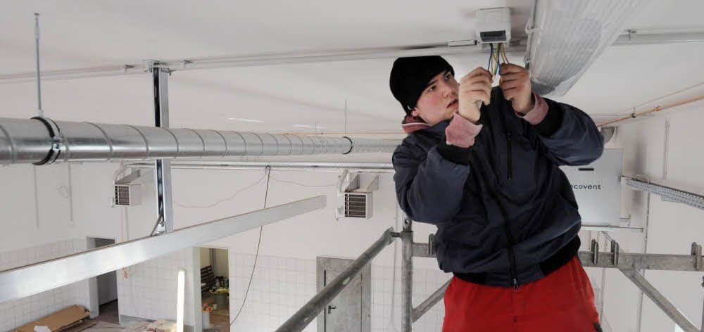 Jannik Henke bringt Lampen in der neuen Feuerwehr-Garage an.