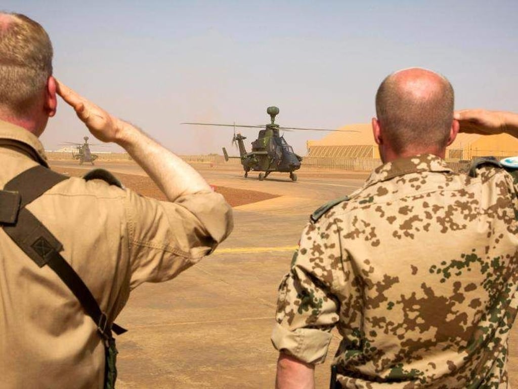 Zwei Bundeswehrsoldaten salutieren während der Ankunft der ersten zwei Kampfhubschrauber des Typs Tiger in Gao, Mali. Foto: Marc Tessensohn/Archiv