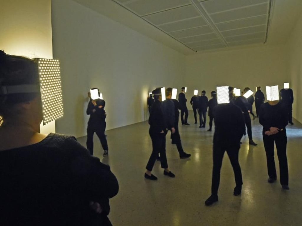 Dunkel gekleidete Figuren mit leuchtenden Visieren im Sprengel Museum in Hannover. Foto: Holger Hollemann