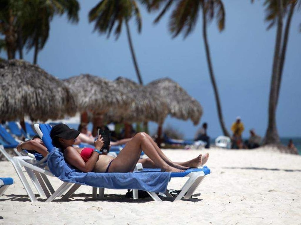 Urlauber können am Strand von Punta Cana in der Dominikanischen Republik ausspannen. Das Wasser ist dort 25 Grad warm. Foto: Orlando Barria/EFE/dpa/Archiv
