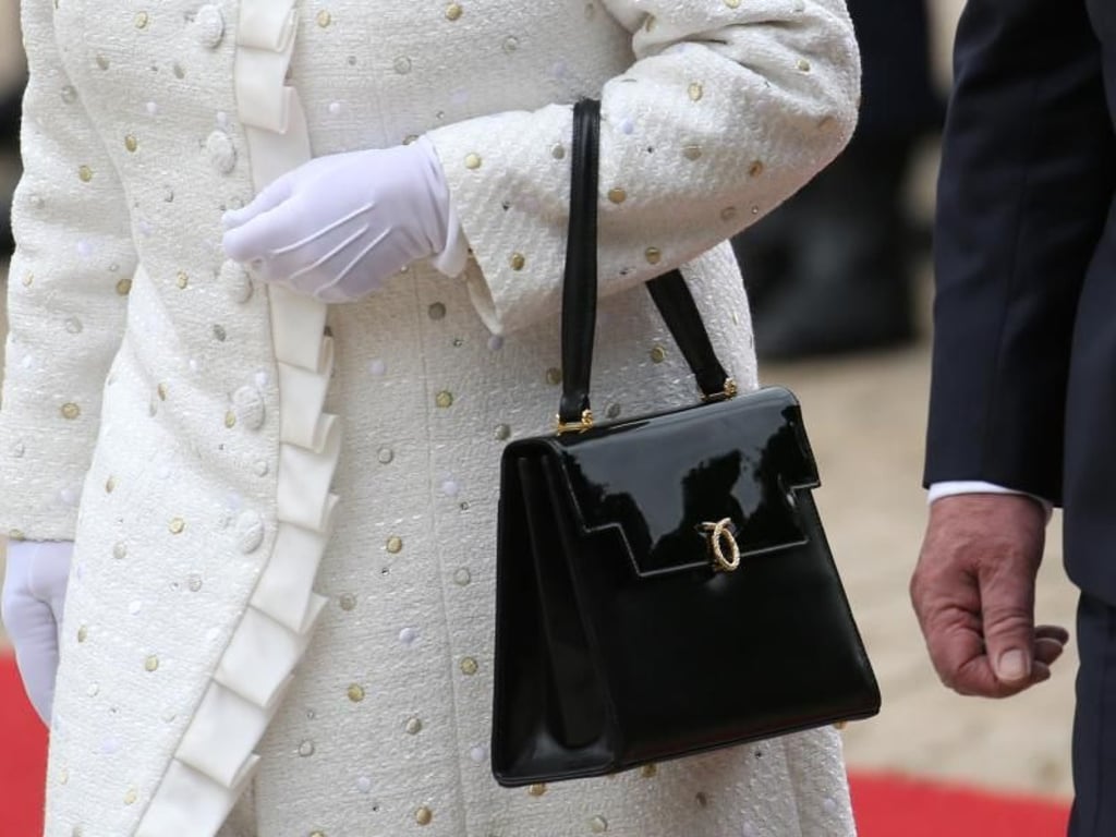 Die Queen bevorzugt klassische Henkeltaschen. Diese trägt sie in der Armbeuge. Foto: Michael Kappeler/dpa