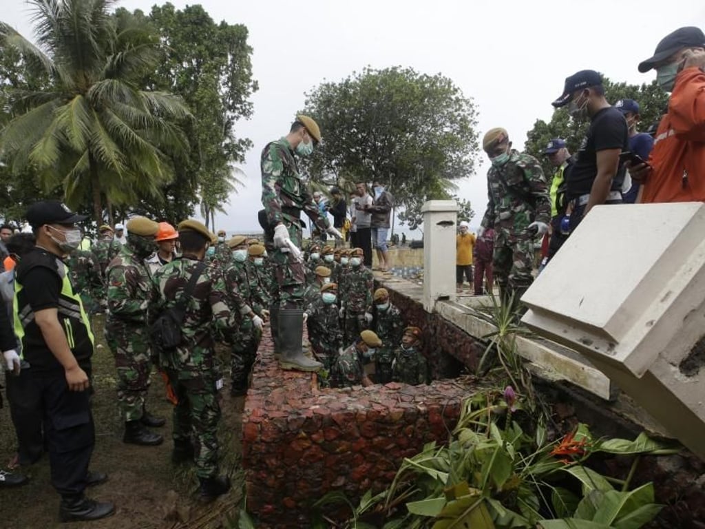 Indonesische Soldaten und Rettungskräfte suchen in einem Strand-Ressort nach Opfern. Foto: Achmad Ibrahim/AP