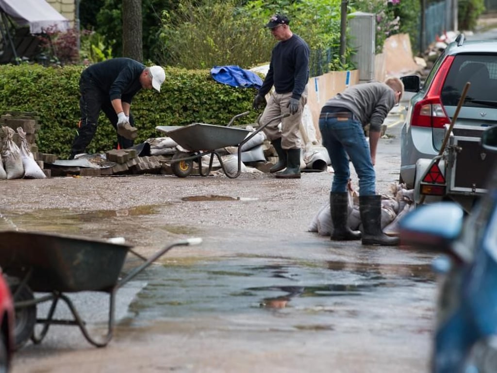 Anwohner räumen nach dem Hochwasser in Rhüden auf. Foto: Swen Pförtner