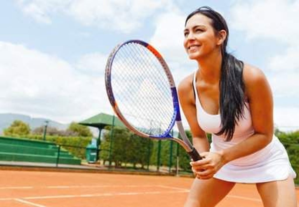 Woman playing tennis and waiting for the service