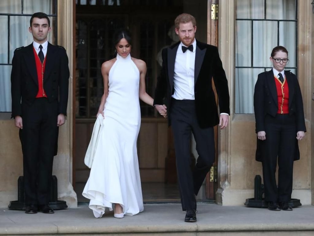 Prinz Harry und seine Frau Meghan verlassen Schloss Windsor um zum Hochzeitsfest im Frogmore House zu fahren. Foto: Steve Parsons/PA Wire