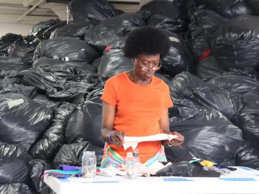 Eine freiwillige Mitarbeiterin der Firma «FabScrap» sortiert Stoffreste. Foto: Christina Horsten