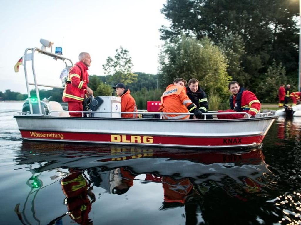 Feuerwehrleute und Helfer der DLRG transportieren Sandsäcke und Arbeitsgerät zur Deichsicherung bei Hildesheim. Foto: Hauke-Christian Dittrich