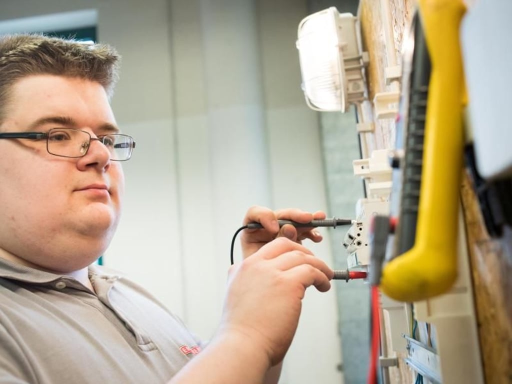 Gibt es ein Problem? Fehleranalyse ist eine typische Aufgabe von Elektronikern für Gebäude- und Infrastruktursysteme. Hier überprüft Jean-Pascal die Spannung in einem Sicherungskasten. Foto: Franziska Gabbert