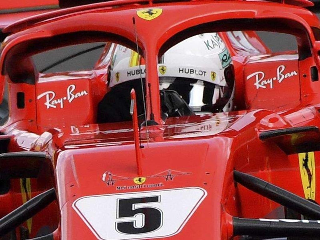 Sebastian Vettel rast in seinem Ferrari in Spa-Francorchamps über die Strecke. Foto: Geert Vanden Wijngaert/AP