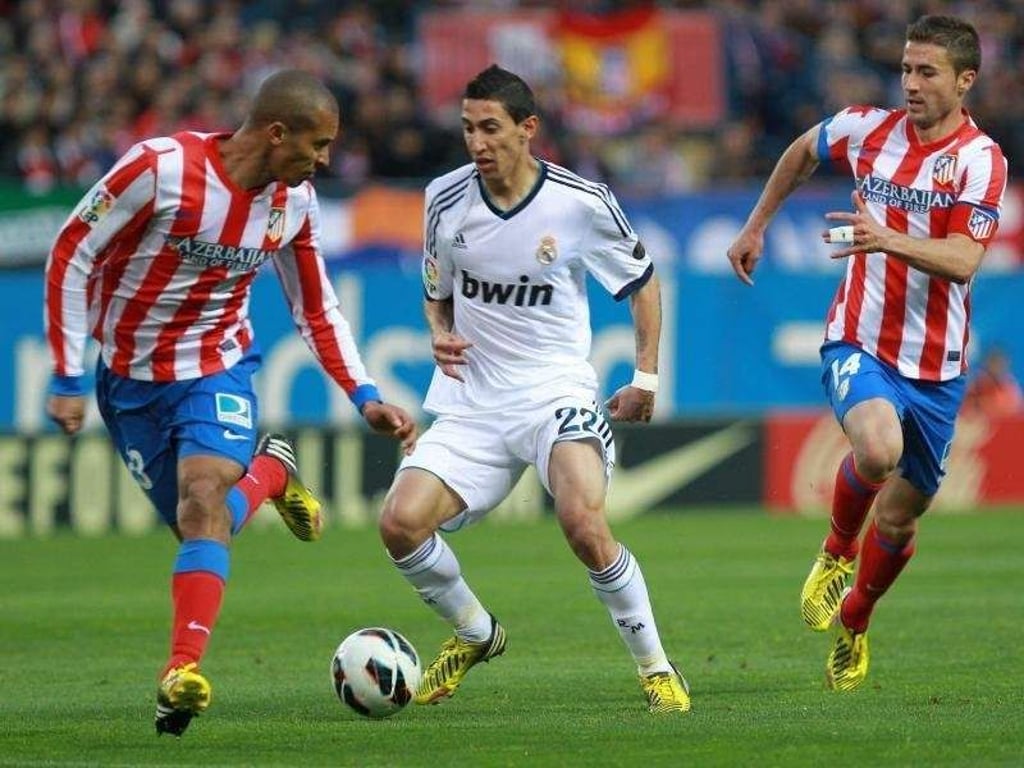 Real Madrids Angel di Maria (M) behauptet sich gegen Atléticos Joao Miranda (l) and Gabi Fernandez. Foto: Zipi