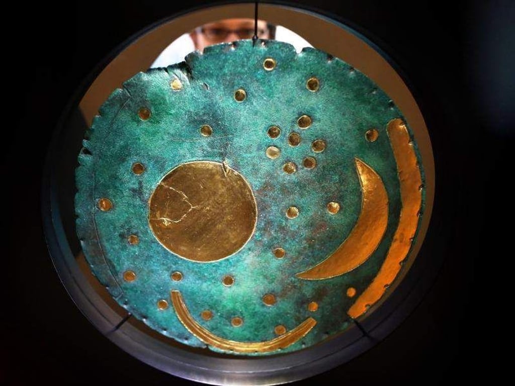 Eine Besucherin betrachtet eine Nachbildung der Himmelsscheibe. Foto: Jan Woitas/Archiv