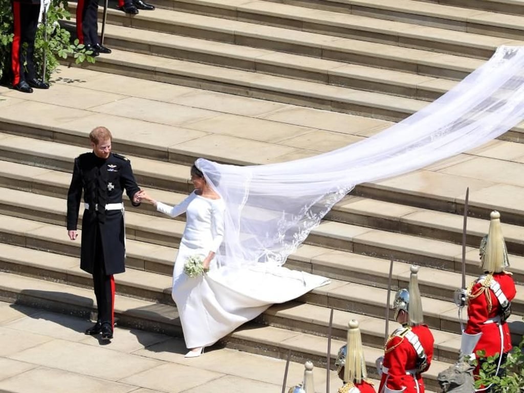Prinz Harry und seine Frau Meghan schweben nach der Trauung die Stufen der St.-Georgs-Kapelle hinab. Foto: Andrew Matthews/PA Wire