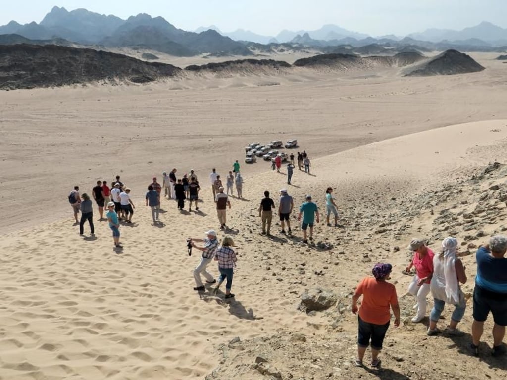 Immer dem Reiseleiter nach: Kreuzfahrt-Touristen auf einem Landausflug in der Wüste von Safaga in Ägypten. Foto: Andrea Warnecke/dpa-tmn