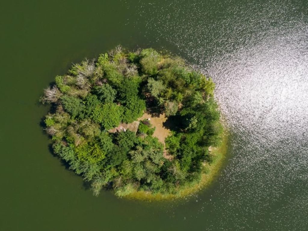 Blick von oben: Die Sonne scheint auf eine kleine Insel im Irenensee in Niedersachsen. Foto: Christophe Gateau