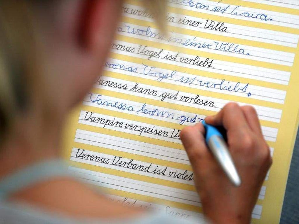 Eine Grundschülerin übt Schreibschrift. Foto: Jan Woitas/Archiv