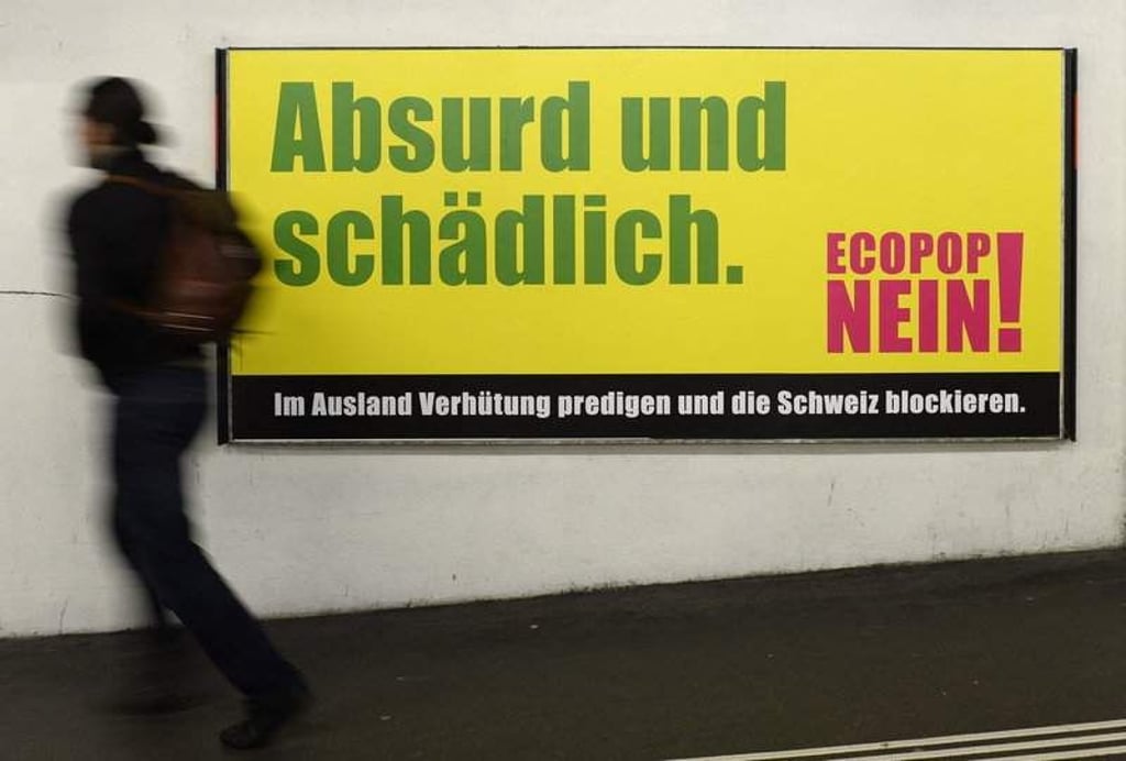 (FILE) A file picture dated 07 November 2014 shows a man pases a poster saying 'NO' to the Ecopop initiative in Zurich. The Swiss are sceptical of a controversial proposal to limit population growth in order to reduce Switzerland's ecological footprint, according to the results of an opinion poll five weeks ahead of a vote on the issue. Only one in three (35 per cent) people surveyed said they would vote yes on 30 November 2014. Ecopop - launched by a committee of ecologists - wants to limit net immigration to 0.2 per cent of population growth - about 16,000 people annually. EPA/STEFFEN SCHMIDT (zu dpa 0067 vom 24.11.2014) +++(c) dpa - Bildfunk+++
