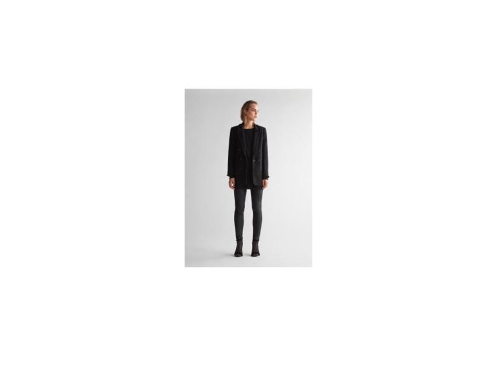 Gerade Schwarz ist eine beliebte Farbe für das monochrome Outfit, hier bei Oui zu sehen (Blazer ca. 200 Euro, Pullover ca. 140 Euro, Hose ca. 120 Euro). Foto: Oui/dpa-tmn