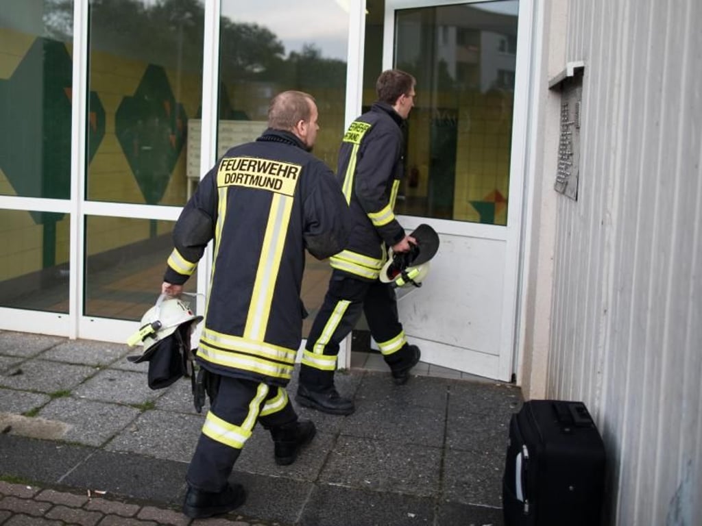 Feuerwehrleute betreten den Hochhauskomplex. Foto: Marcel Kusch