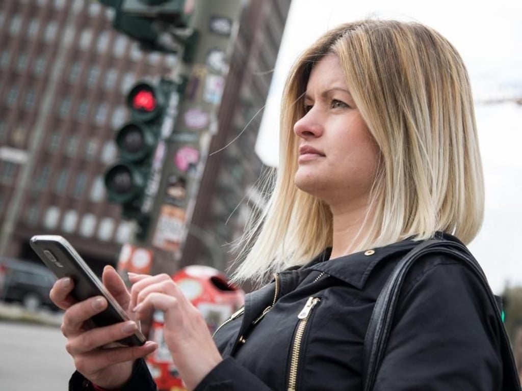 Ampel rot, Smartphone raus: Viele Menschen greifen in jeder freien Sekunde nach ihrem Mobilgerät. Foto: Christin Klose/dpa-tmn