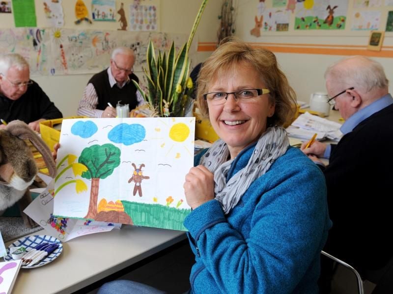 Als eine der Helferinnen von Hanni Hase im Osterhasenbüro hält die Bürgermeisterin von Ostereistedt, Ulrike Ringen, im Postamt von Zeven (Niedersachsen) einen liebevoll gemalten Kinderbrief in den Händen. Foto: Ingo Wagner/dpa